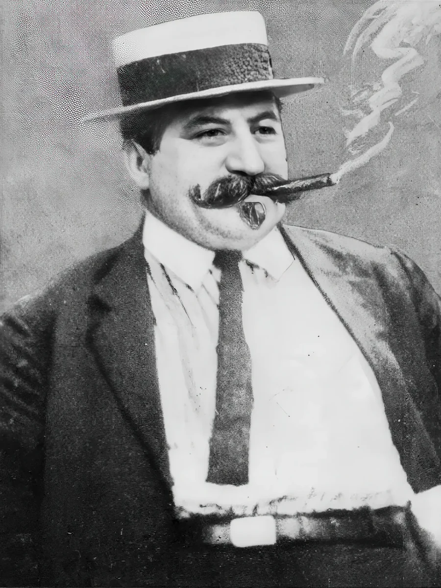 A halftone portrait of a man in a straw boater hat with a heavy moustache, smoking a cigar.