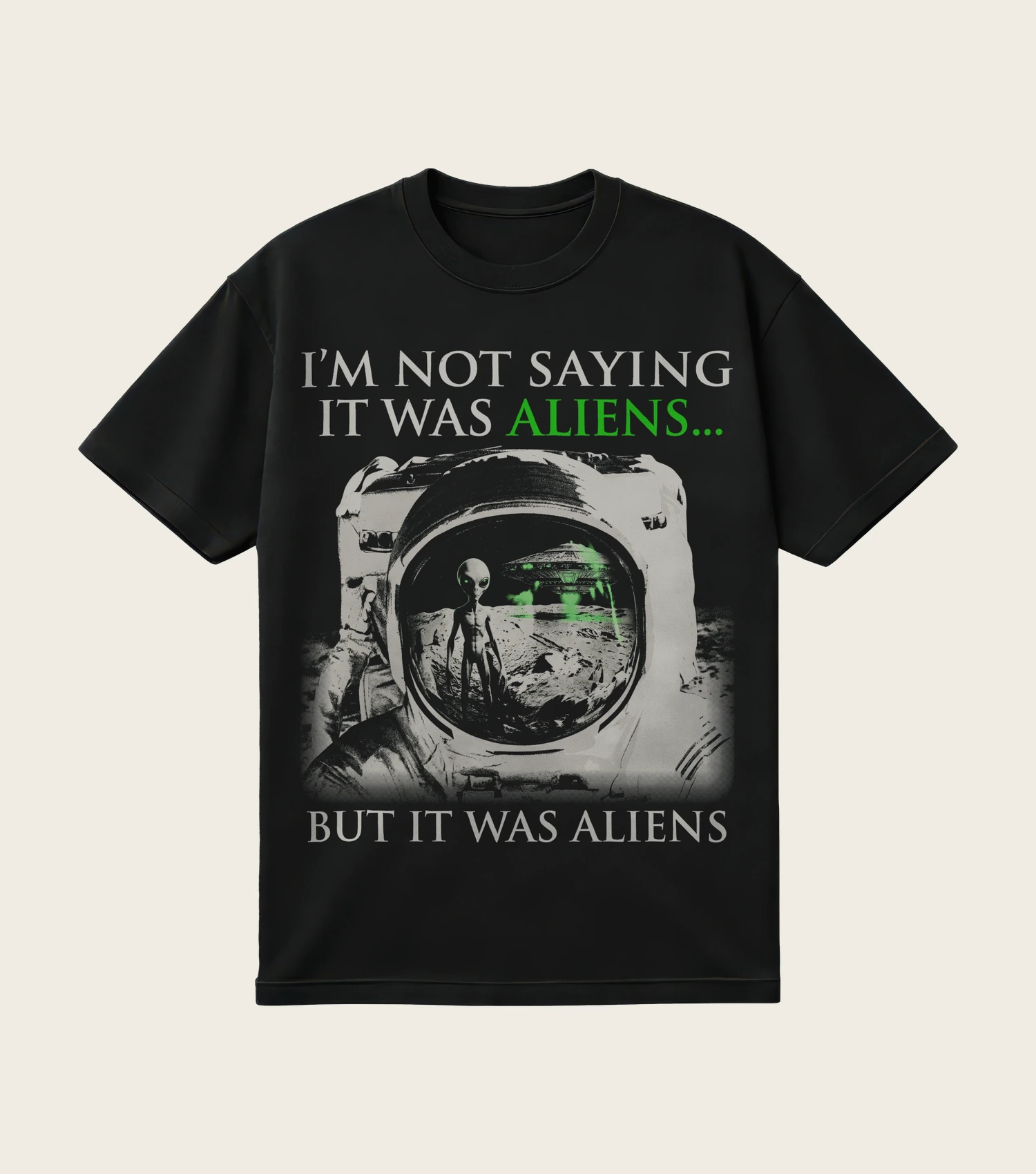 I'm Not Saying It Was Aliens printed on a black t-shirt, laid flat