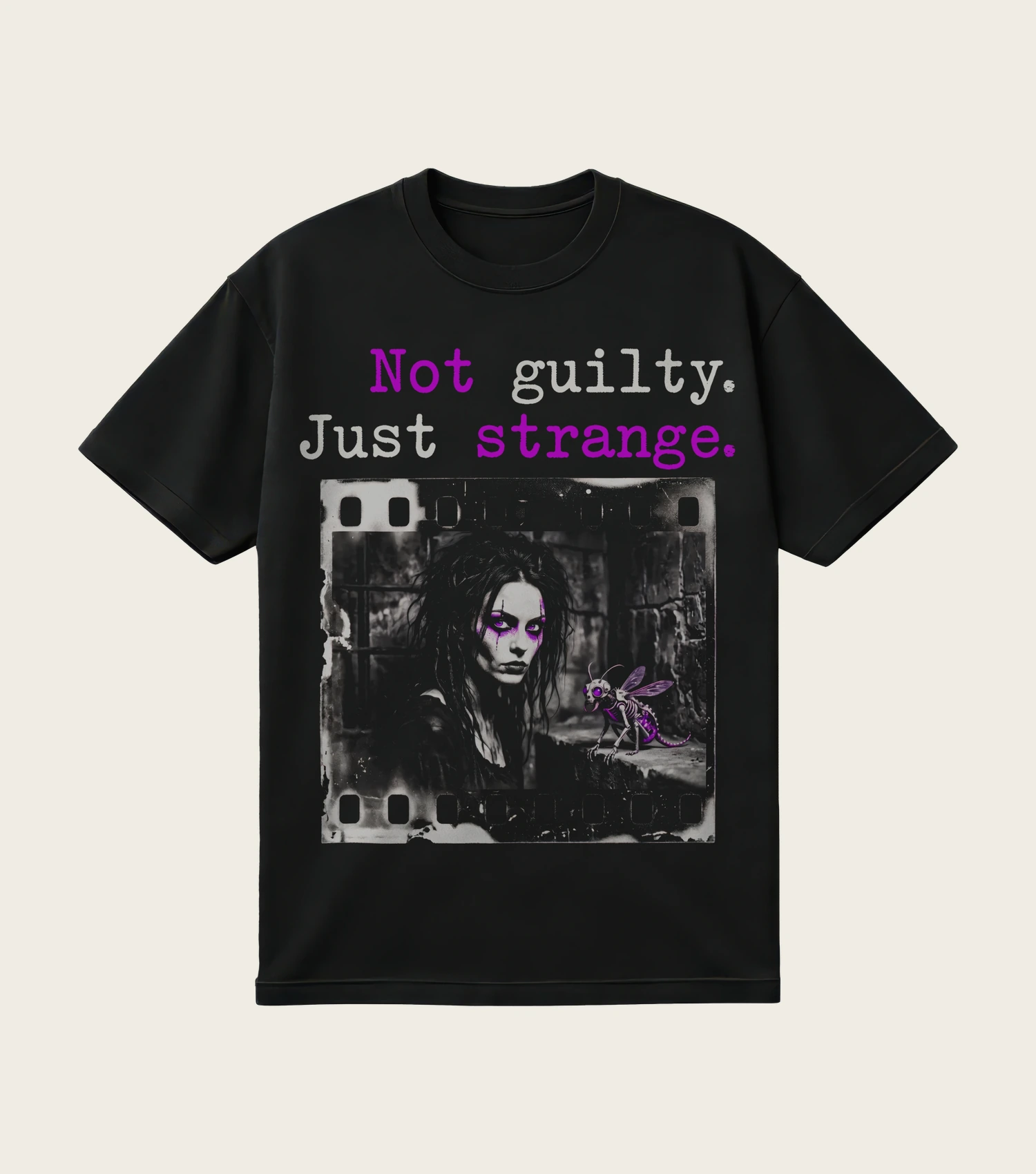 Not Guilty. Just Strange. printed on a black t-shirt, laid flat