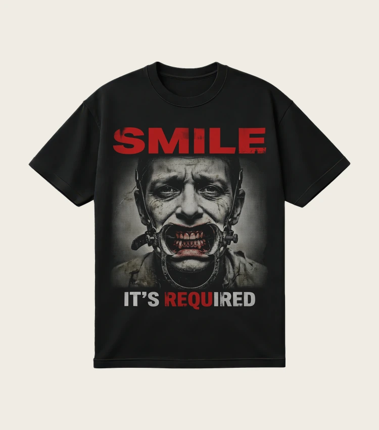 Smile. It's Required. printed on a black t-shirt, laid flat