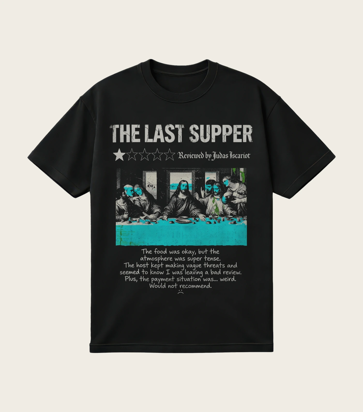 The Last Supper: Judas Review printed on a black t-shirt, laid flat